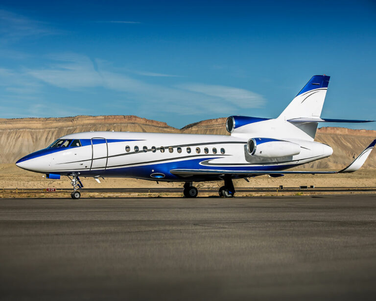 A small private jet plane rests on the tarmac, ready for its next trip.