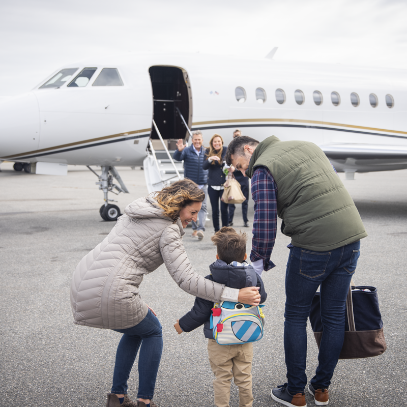 A family comes together, welcomed as they get ready to board a private jet.